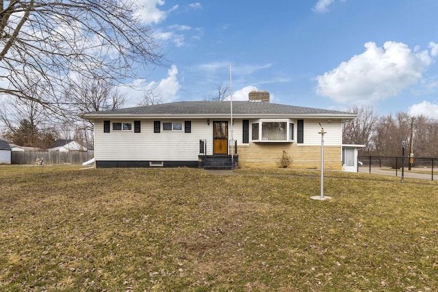 ranch-style house featuring a chimney, fence, and a front yard