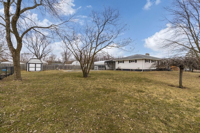 view of yard featuring a storage shed, an outbuilding, and a fenced backyard