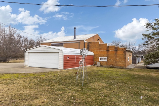 view of property exterior featuring a garage, a lawn, and cooling unit