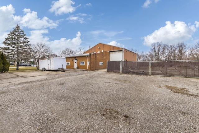 exterior space featuring a garage and fence