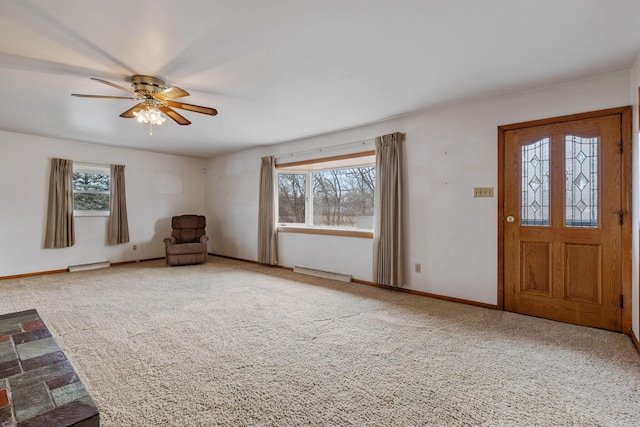 foyer featuring carpet floors, a healthy amount of sunlight, a baseboard radiator, and baseboards