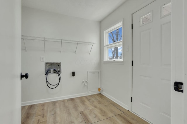 laundry area featuring gas dryer hookup, hookup for a washing machine, laundry area, baseboards, and light wood finished floors