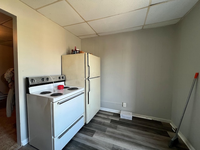 kitchen with dark wood-style floors, white appliances, a paneled ceiling, and baseboards