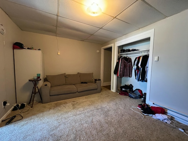 unfurnished living room featuring a paneled ceiling, carpet, and baseboard heating