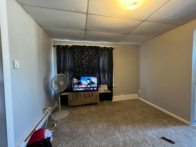 interior space featuring baseboard heating, a paneled ceiling, and baseboards