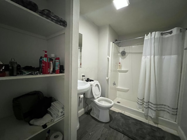 full bath featuring a stall shower and toilet