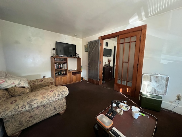 living room with dark colored carpet