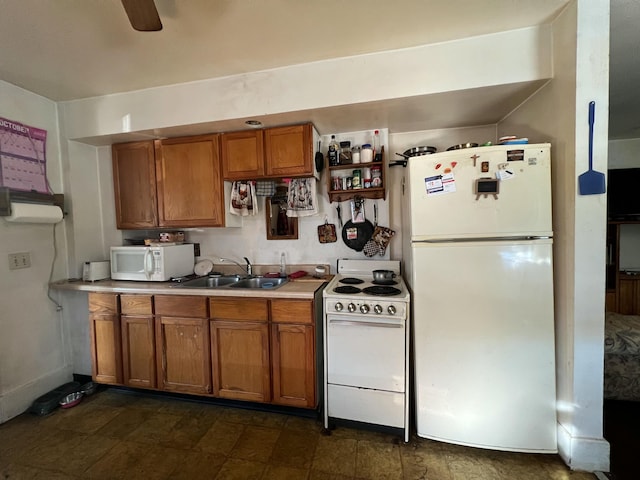 kitchen with white appliances, ceiling fan, brown cabinets, light countertops, and a sink