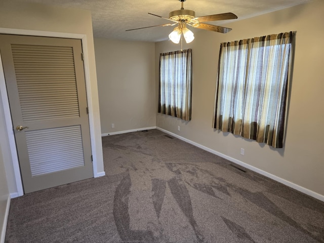 unfurnished bedroom featuring visible vents, baseboards, a ceiling fan, carpet, and a textured ceiling