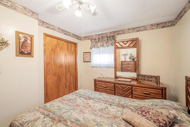 bedroom featuring a ceiling fan and a closet