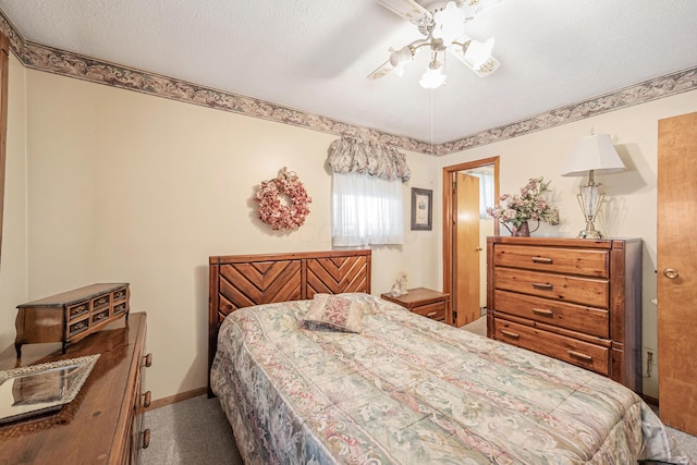 bedroom with a ceiling fan, carpet flooring, a textured ceiling, and baseboards