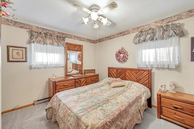 bedroom featuring light colored carpet, a baseboard radiator, multiple windows, and a textured ceiling