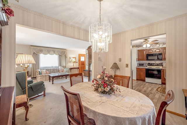 dining room featuring baseboards, a toaster, light colored carpet, and wallpapered walls