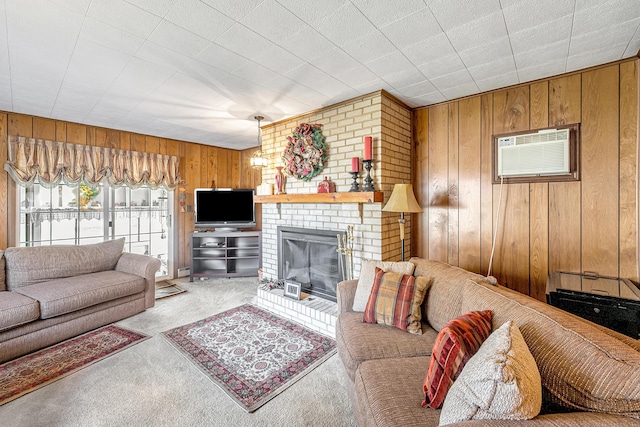 living area with carpet floors, a notable chandelier, a fireplace, an AC wall unit, and wood walls