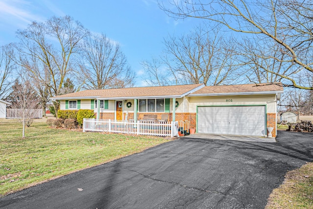 ranch-style home with brick siding, driveway, and fence