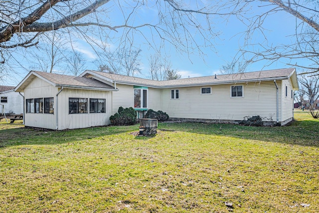 back of house with a lawn