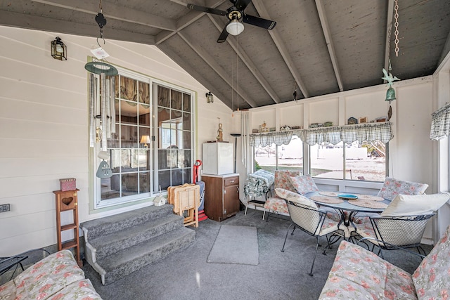 sunroom / solarium with a ceiling fan and lofted ceiling with beams