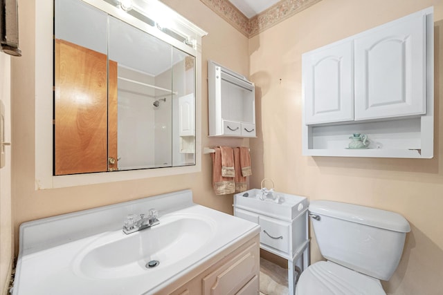 full bathroom featuring walk in shower, vanity, and toilet