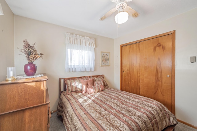 carpeted bedroom featuring a closet and ceiling fan