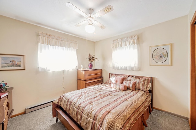 bedroom with carpet floors, baseboards, baseboard heating, and a ceiling fan