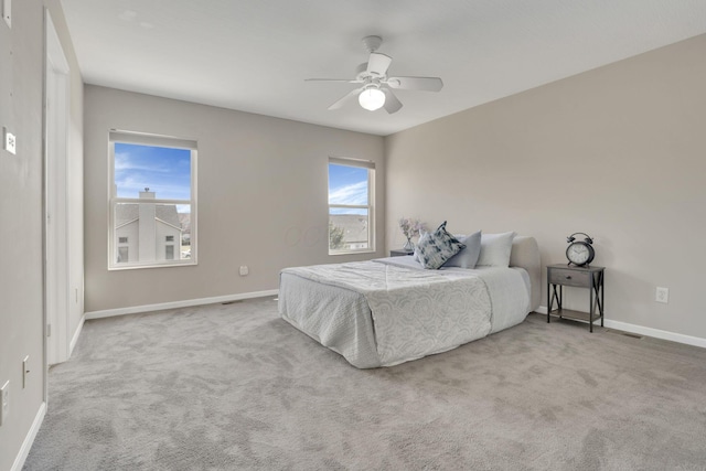 carpeted bedroom featuring baseboards and ceiling fan