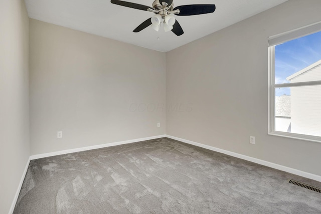 spare room with visible vents, baseboards, carpet, and ceiling fan