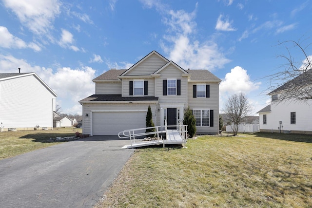 view of front of home featuring driveway, an attached garage, and a front yard