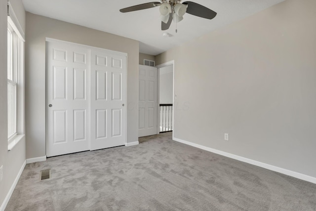 unfurnished bedroom featuring carpet, visible vents, and baseboards