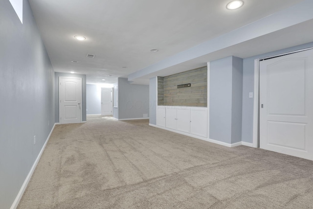 unfurnished living room featuring recessed lighting, carpet, and baseboards