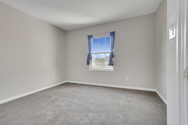 carpeted empty room with baseboards