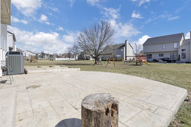 view of patio with a residential view, playground community, and central AC