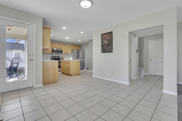 kitchen featuring backsplash, light brown cabinetry, light countertops, light tile patterned floors, and stainless steel appliances