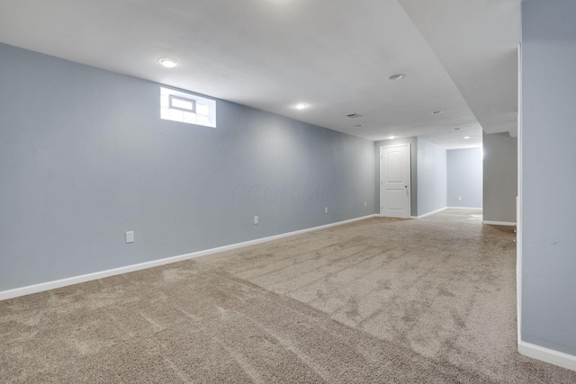 below grade area with baseboards and carpet floors