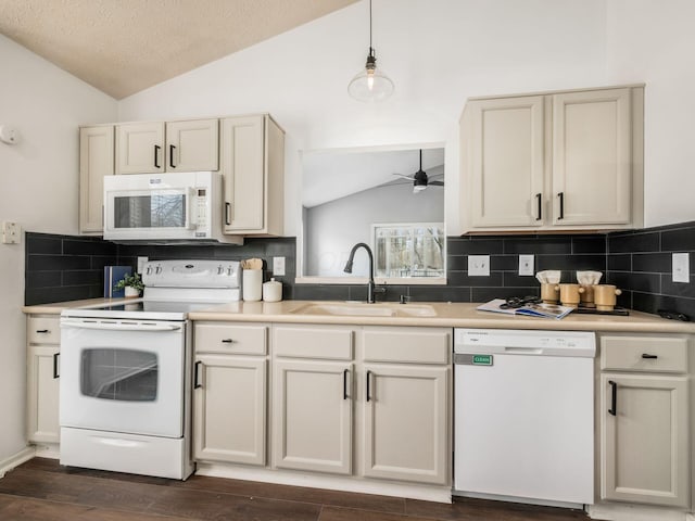 kitchen featuring white appliances, a ceiling fan, dark wood-type flooring, vaulted ceiling, and a sink