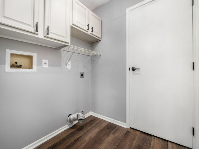 washroom with dark wood finished floors, hookup for a washing machine, cabinet space, electric dryer hookup, and baseboards