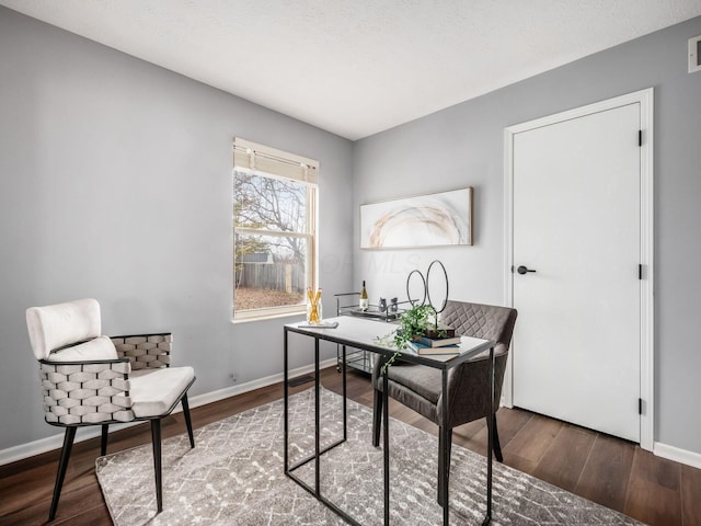 office space featuring baseboards and wood finished floors