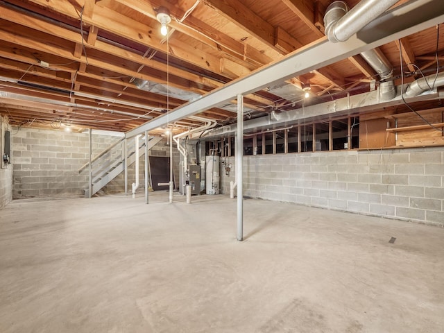 unfinished basement featuring water heater