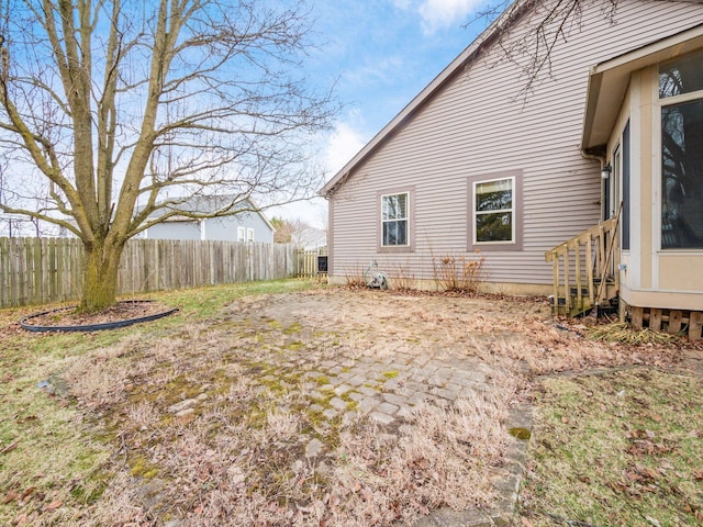 view of side of property featuring fence