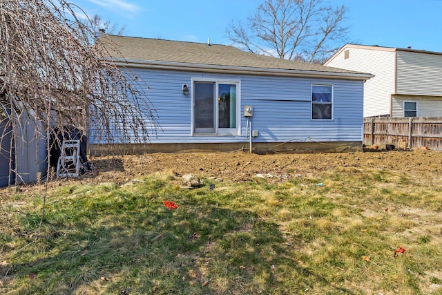 rear view of property featuring fence