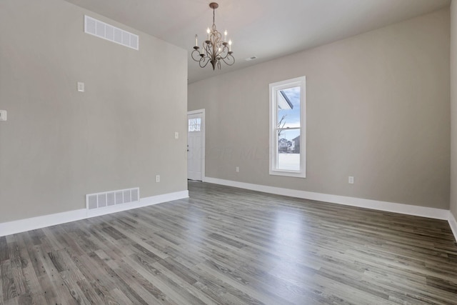 32 Railroad St, Jeffersonville, OH 43128 - empty room featuring a chandelier, wood finished floors, and baseboards