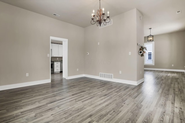 32 Railroad St, Jeffersonville, OH 43128 - empty room featuring a chandelier, dark wood-type flooring, and baseboards