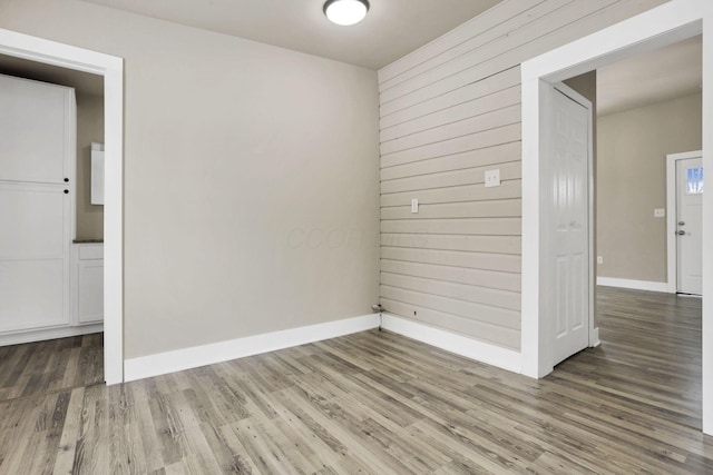 32 Railroad St, Jeffersonville, OH 43128 - spare room featuring wood finished floors, baseboards, and wood walls