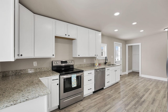 32 Railroad St, Jeffersonville, OH 43128 - kitchen with appliances with stainless steel finishes, a sink, white cabinetry, recessed lighting, and light wood finished floors