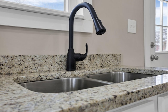 32 Railroad St, Jeffersonville, OH 43128 - kitchen view of a sink, white cabinetry, and light stone countertops