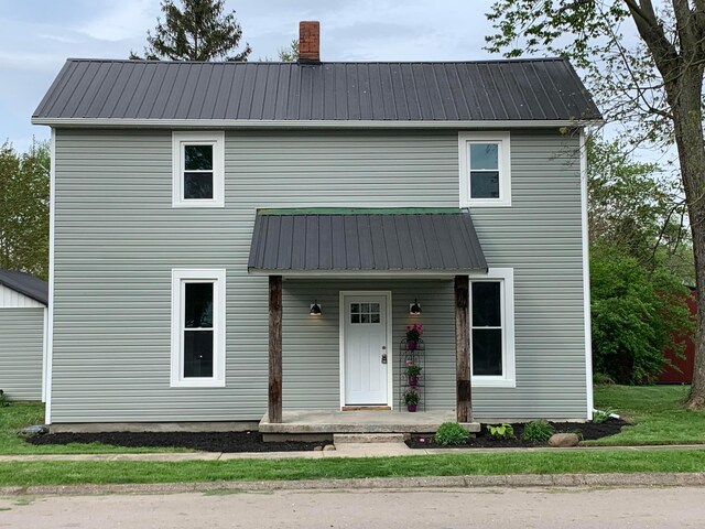 32 Railroad St, Jeffersonville, OH 43128 - view of front of home featuring metal roof, a porch, and a chimney