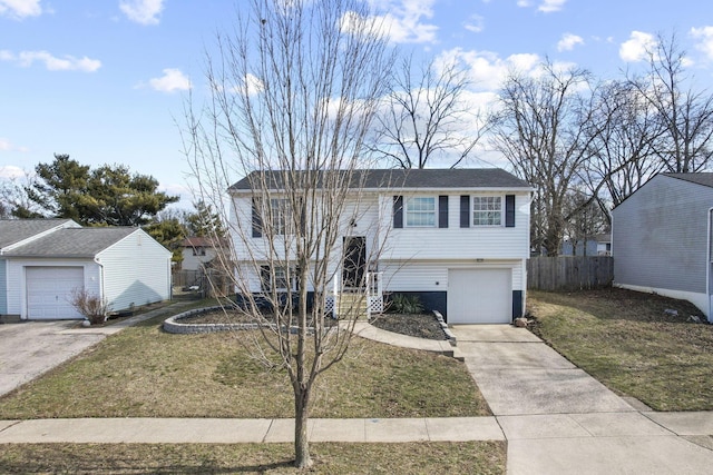 raised ranch featuring driveway, a garage, fence, and a front yard