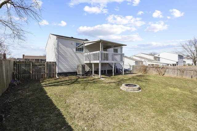 rear view of house featuring an outdoor fire pit, stairs, a lawn, and a fenced backyard