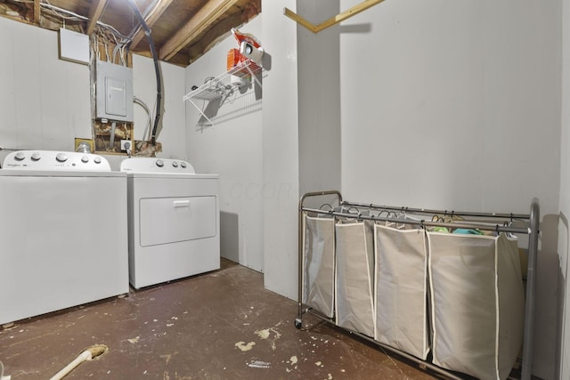 laundry room with laundry area, electric panel, and washing machine and clothes dryer