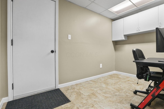 office with a drop ceiling and baseboards