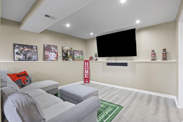 living area featuring recessed lighting, visible vents, baseboards, and wood finished floors